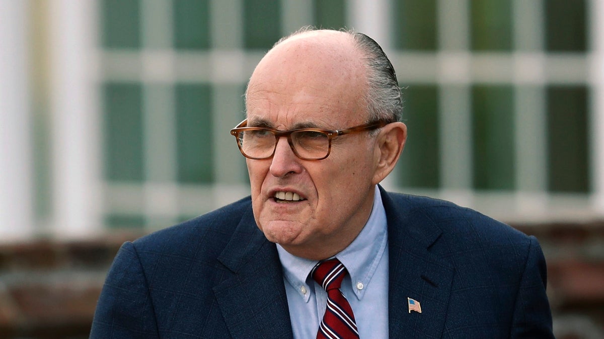 FILE - In this Nov. 20, 2016 file photo, former New York Mayor Rudy Giuliani arrives at the Trump National Golf Club Bedminster clubhouse in Bedminster, N.J. President Donald Trump's new lawyer Rudy Giuliani said Wednesday, May 2, 2018, the president repaid attorney Michael Cohen for a $130,000 payment to porn star Stormy Daniels. Giuliani made the revelation during an appearance on Fox News Channel's 