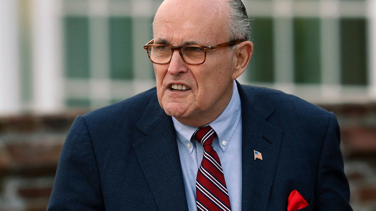 FILE - In this Nov. 20, 2016 file photo, former New York Mayor Rudy Giuliani arrives at the Trump National Golf Club Bedminster clubhouse in Bedminster, N.J. President Donald Trump's new lawyer Rudy Giuliani said Wednesday, May 2, 2018, the president repaid attorney Michael Cohen for a $130,000 payment to porn star Stormy Daniels. Giuliani made the revelation during an appearance on Fox News Channel's 