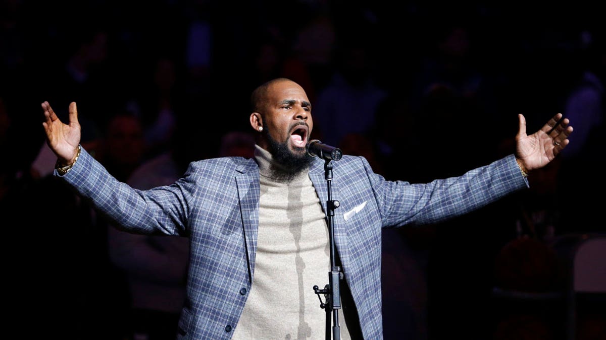 FILE - In this Nov. 17, 2015, file photo, musical artist R. Kelly performs the national anthem before an NBA basketball game between the Brooklyn Nets and the Atlanta Hawks in New York. As critics of the singer seek to cancel his shows because of his alleged mistreatment of women, a community leader in North Carolina says she and others will stage a protest if his Friday show in Greensboro takes place. (AP Photo/Frank Franklin II, File)