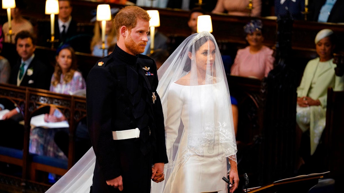 Britain's Prince Harry and Meghan Markle stand, prior to the start of their wedding ceremony, at St. George's Chapel in Windsor Castle in Windsor, near London, England, Saturday, May 19, 2018. (Dominic Lipinski/pool photo via AP)