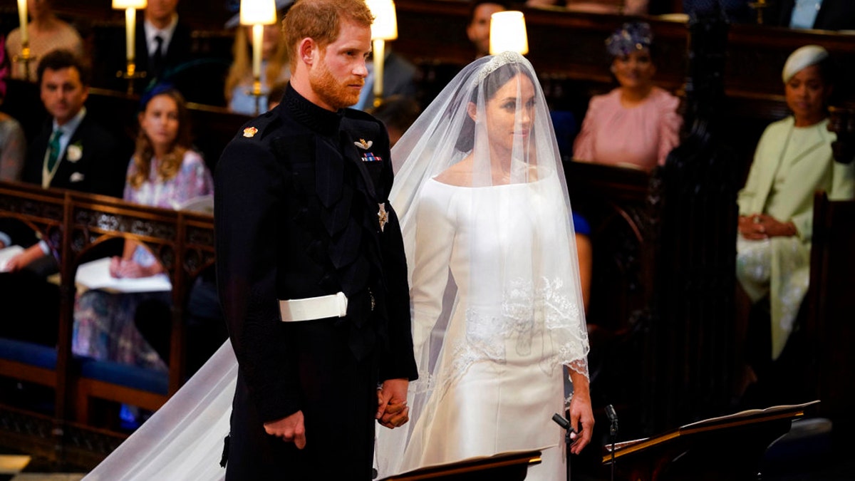 Britain's Prince Harry and Meghan Markle stand, prior to the start of their wedding ceremony, at St. George's Chapel in Windsor Castle in Windsor, near London, England, Saturday, May 19, 2018. (Dominic Lipinski/pool photo via AP)