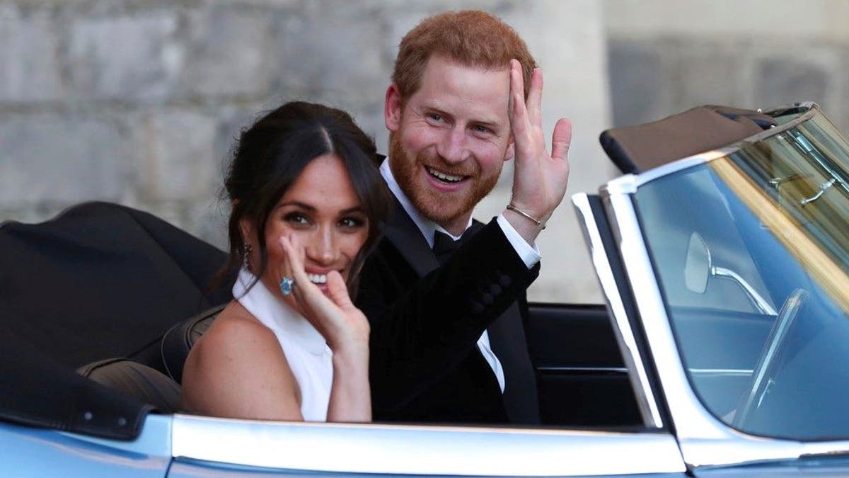 The newly married Duke and Duchess of Sussex, Meghan Markle and Prince Harry, leave Windsor Castle in a convertible car after their wedding in Windsor, England, to attend an evening reception at Frogmore House, hosted by the Prince of Wales, Saturday, May 19, 2018. (Steve Parsons/pool photo via AP)