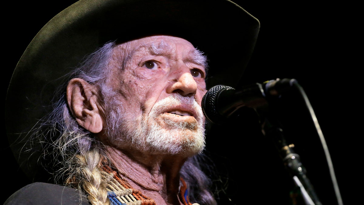 FILE - In this Jan. 7, 2017, file photo, Willie Nelson performs in Nashville, Tenn. Nelson has called out current immigration policies as ???????outrageous??????? and extended an offer to meet President Donald Trump at one of the detention centers at the U.S.-Mexico border. (AP Photo/Mark Humphrey, File)