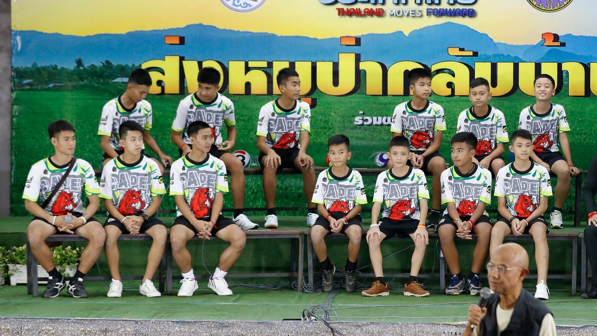 Members of the rescued soccer team and their coach sit during a press conference discussing their ordeal in the cave in Chiang Rai, northern Thailand, Wednesday, July 18, 2018. The 12 boys and their soccer coach rescued after being trapped in a flooded cave in northern Thailand are recovering well and are eager to eat their favorite comfort foods after their expected discharge from a hospital soon. (AP Photo/Vincent Thian)