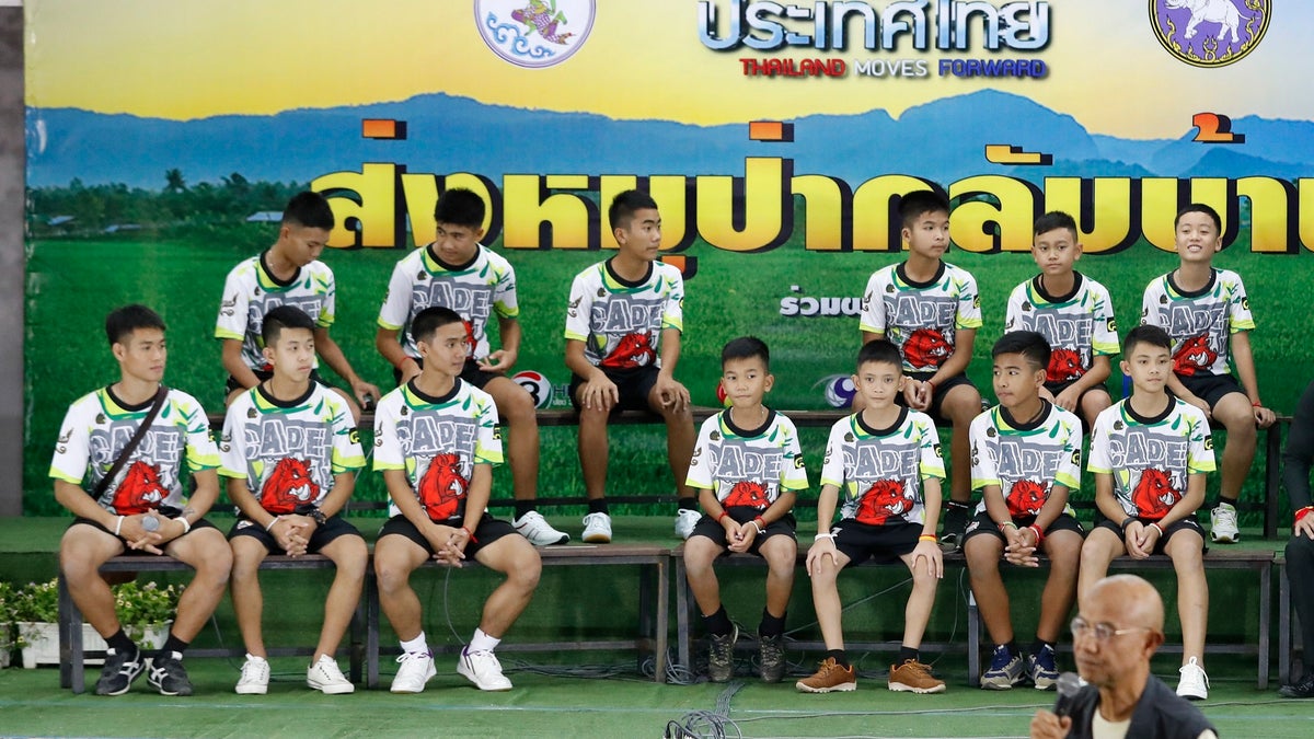 Members of the rescued soccer team and their coach sit during a press conference discussing their ordeal in the cave in Chiang Rai, northern Thailand, Wednesday, July 18, 2018. The 12 boys and their soccer coach rescued after being trapped in a flooded cave in northern Thailand are recovering well and are eager to eat their favorite comfort foods after their expected discharge from a hospital soon. (AP Photo/Vincent Thian)