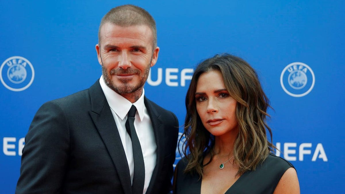 David Beckham, left, and his wife Victoria Beckham arrive for the UEFA Champions League draw at the Grimaldi Forum, in Monaco, Thursday, Aug. 30, 2018. (AP Photo/Claude Paris)