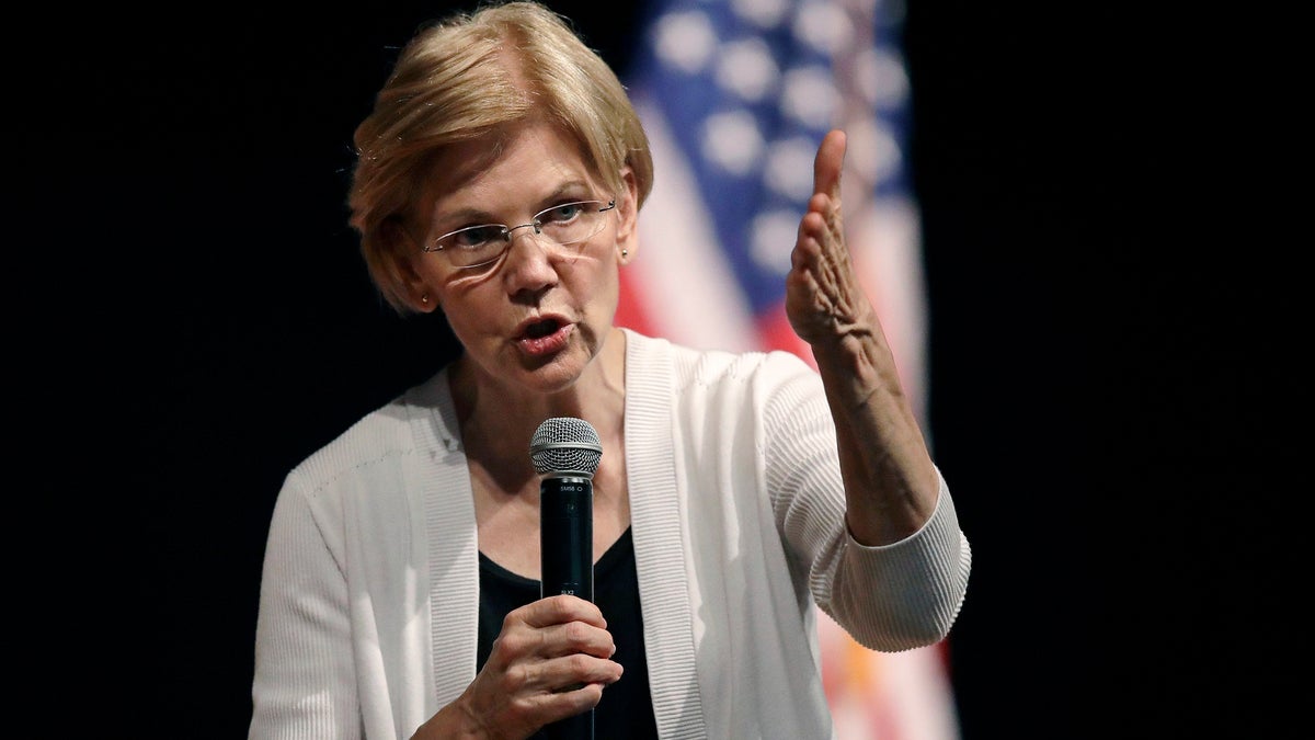 FILE - In this Aug. 8, 2018, file photo, U.S. Sen. Elizabeth Warren, D-Mass., gestures during a town hall style gathering in Woburn, Mass. Harvard University's decision to hire Warren as a law professor in the 1990s was not based on any assertion that she has Native American heritage, according to a report by the Boston Globe. (AP Photo/Charles Krupa, File)