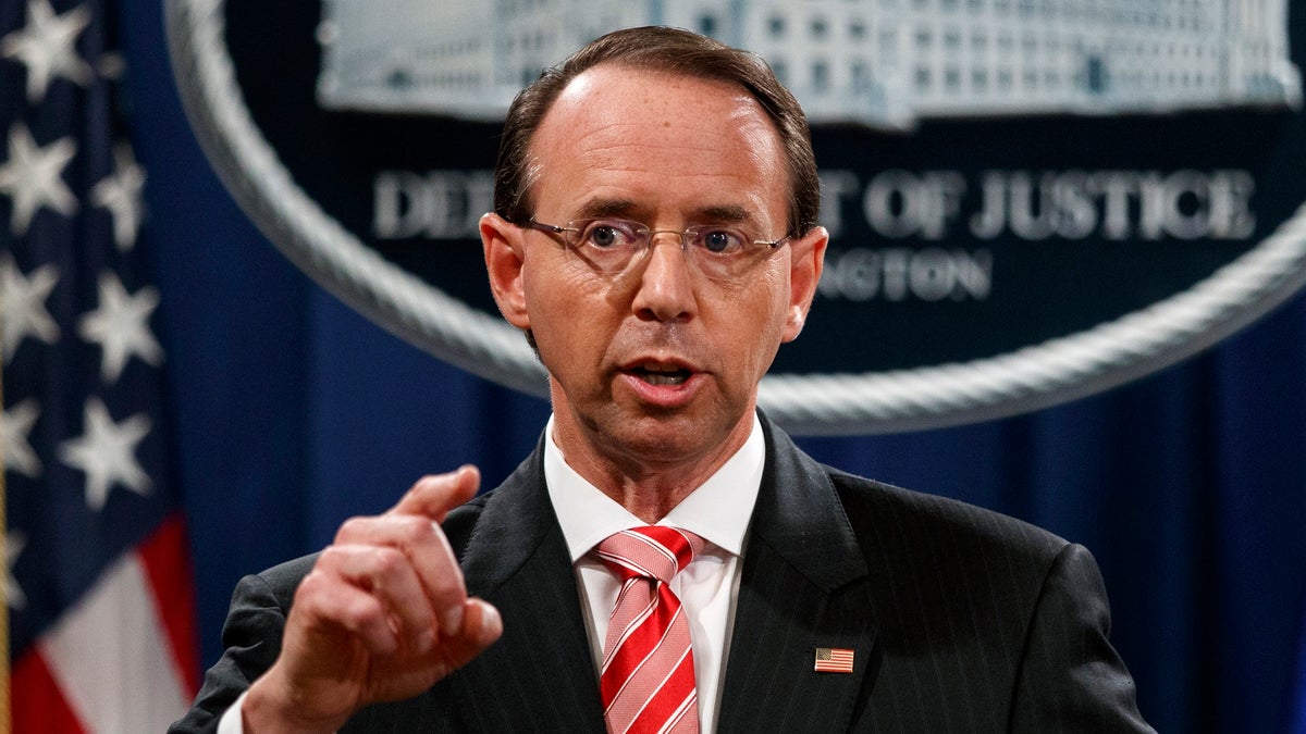 FILE - In this July 13, 2018, file photo, Deputy Attorney General Rod Rosenstein speaks during a news conference at the Department of Justice in Washington. Rosenstein is denying a report in The New York Times that he suggested last year that he secretly record President Donald Trump in the White House to expose the chaos in the administration. Rosenstein says the story is âinaccurate and factually incorrect.â (AP Photo/Evan Vucci, File)