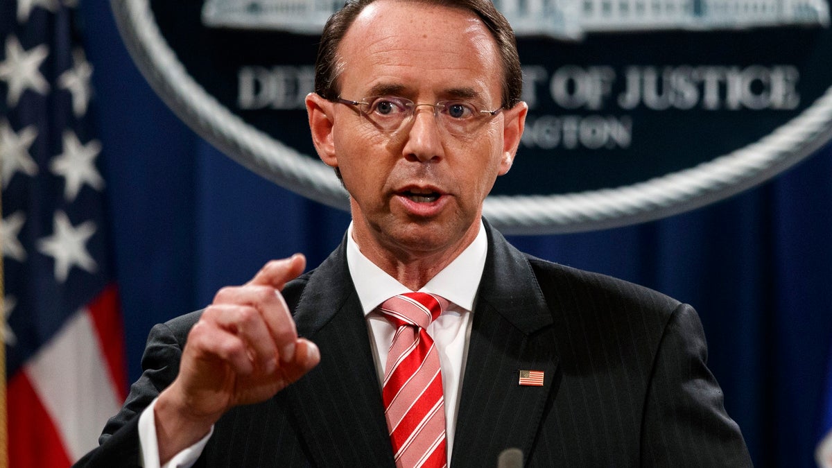 FILE - In this July 13, 2018, file photo, Deputy Attorney General Rod Rosenstein speaks during a news conference at the Department of Justice in Washington. Rosenstein is denying a report in The New York Times that he suggested last year that he secretly record President Donald Trump in the White House to expose the chaos in the administration. Rosenstein says the story is âinaccurate and factually incorrect.â (AP Photo/Evan Vucci, File)