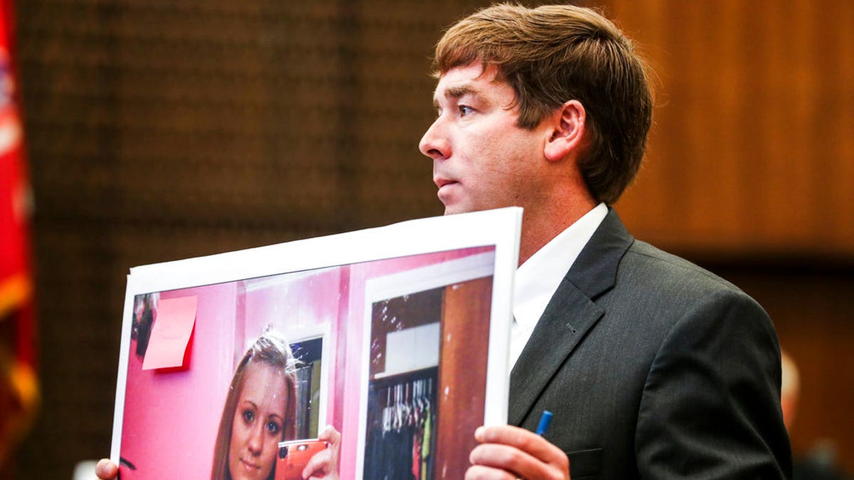 Deputy Prosecutor Jay Hale holds up a picture of Jessica Chambers on the first day of the retrial of Quinton Tellis in Batesville, Miss., Tuesday, Sept. 25 2018. Tellis is charged with burning 19-year-old Jessica Chambers to death almost three years ago on Dec. 6, 2014. Tellis has pleaded not guilty to the murder.  (Brad Vest/The Commercial Appeal via AP, Pool)