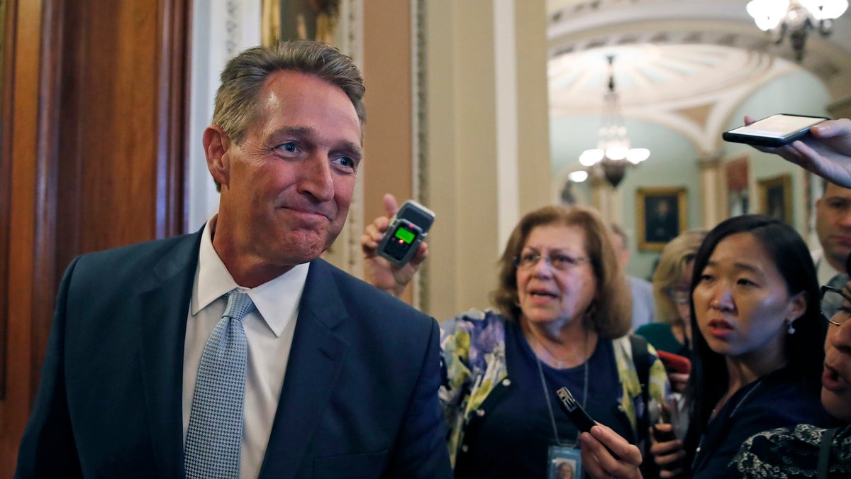 Sen. Jeff Flake, R-Ariz., pauses while speaking to reporters, on Capitol Hill, Wednesday, Sept. 26, 2018, in Washington. (AP Photo/Alex Brandon)