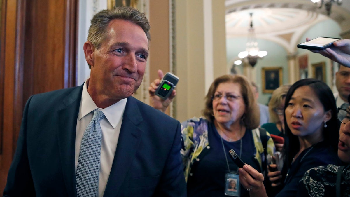 Sen. Jeff Flake, R-Ariz., pauses while speaking to reporters, on Capitol Hill, Wednesday, Sept. 26, 2018, in Washington. (AP Photo/Alex Brandon)