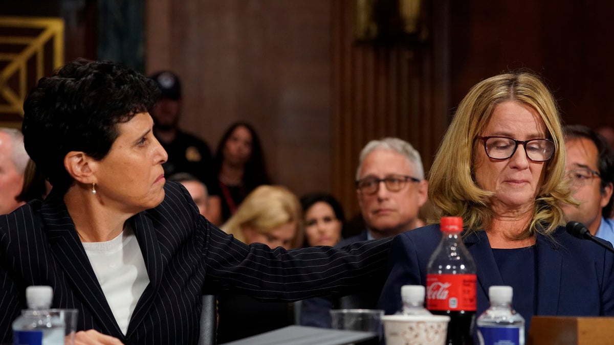 Attorney Debra Katz puts her hand on Christine Blasey Ford as she testifies before the Senate Judiciary Committee on Capitol Hill in Washington, Thursday, Sept. 27, 2018. (AP Photo/Andrew Harnik, Pool)