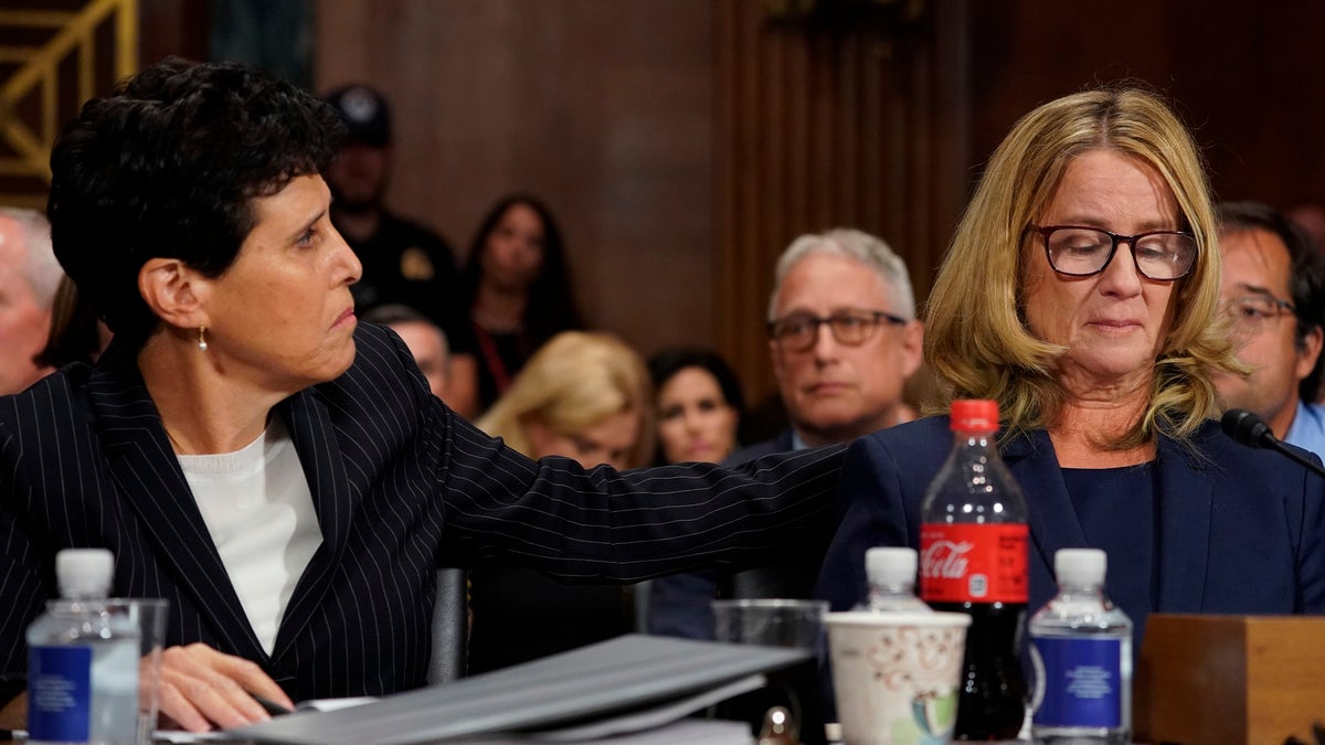 Attorney Debra Katz puts her hand on Christine Blasey Ford as she testifies before the Senate Judiciary Committee on Capitol Hill in Washington, Thursday, Sept. 27, 2018. (AP Photo/Andrew Harnik, Pool)