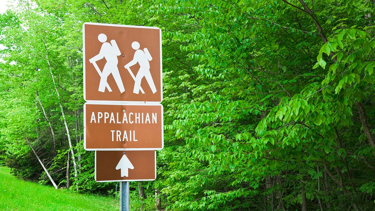 Appalachian Trail hiking sign with trees in background
