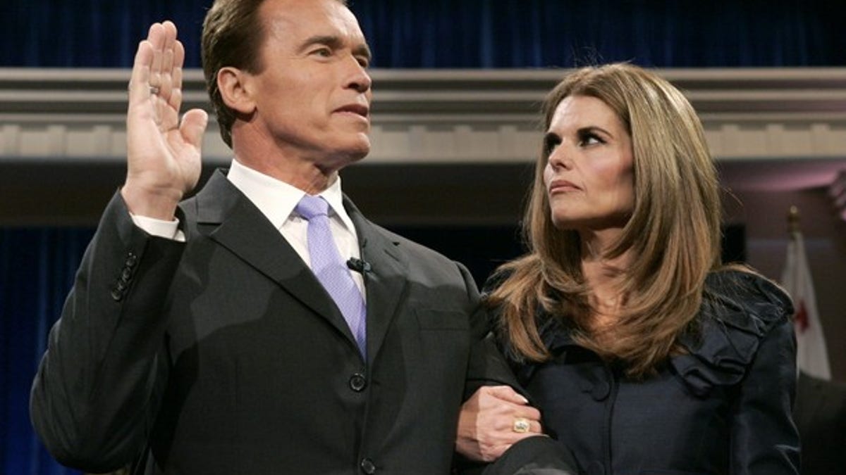 California Governor Arnold Schwarzenegger is joined by his wife Maria Shriver while being sworn into office for a second term by Supreme Court Chief Justice Ronald George (unseen) during his inauguration ceremony at the Memorial Auditorium in Sacramento, California in this January 5, 2007 file photo. Former California Governor Arnold Schwarzenegger has acknowledged that he fathered a child more than ten years ago with a member of his household staff, the Los Angeles Times reported on May 17, 2011. REUTERS/Rich Pedroncelli/Pool/Files (UNITED STATES - Tags: POLITICS ENTERTAINMENT)