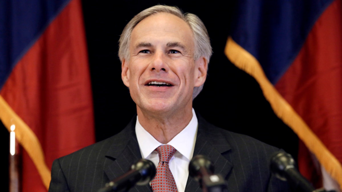 FILE - In this Nov. 4, 2013 file photo, Republican candidate for governor, Texas Attorney General Greg Abbott smiles as he responds to a reporter's questions during a news conference in Dallas. In the nationâs first primary of the season, Texas politicians scramble to fill a void left by an extraordinary shakeup in state offices. (AP Photo/Tony Gutierrez, File)