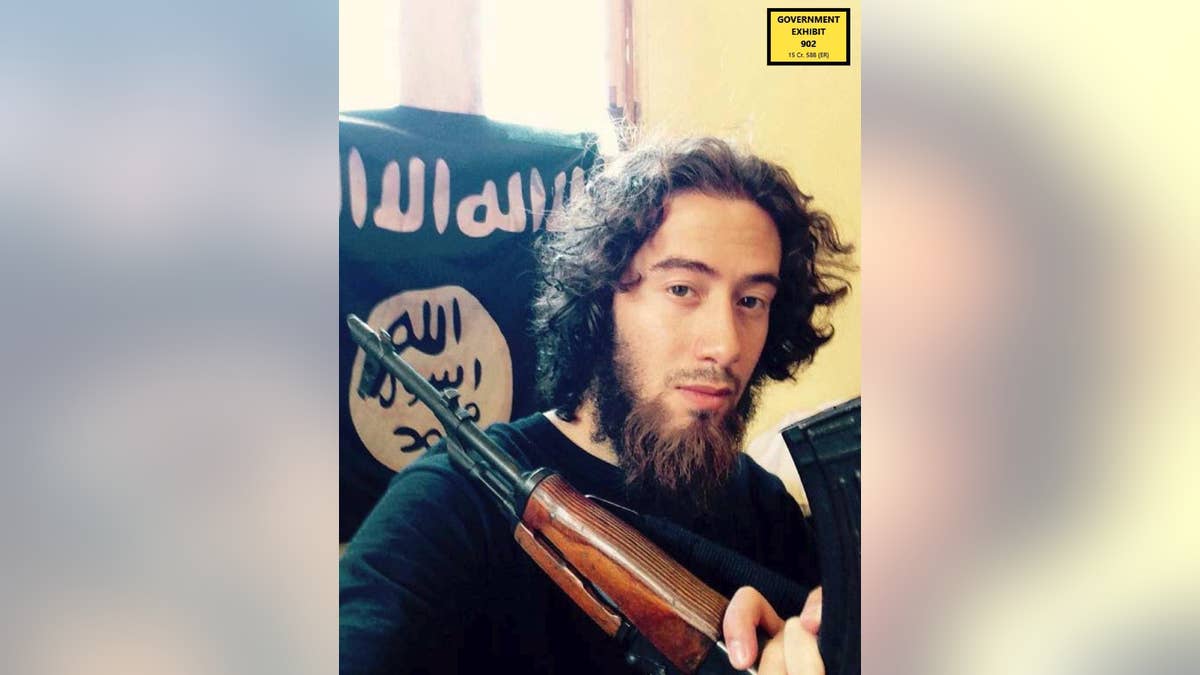 In this undated photo provided by the United States Attorney for the Southern District of New York, Samy el-Goarany poses for a photo with a weapon and the Islamic State group flag. Prosecutors showed this photo of Samy el-Goarany in federal court Tuesday, Jan. 17, 2017, during the trail of Ahmed Mohammed el-Gammal who is accused of helping Samy el-Goarany reach Syria where he trained with the Islamic State group before he was killed. The photo was shown while Samy el-Goarany's brother, Tarek el-Goarany, was testifying. (U.S. Attorney's Office for the Southern Distirct of New York via AP)