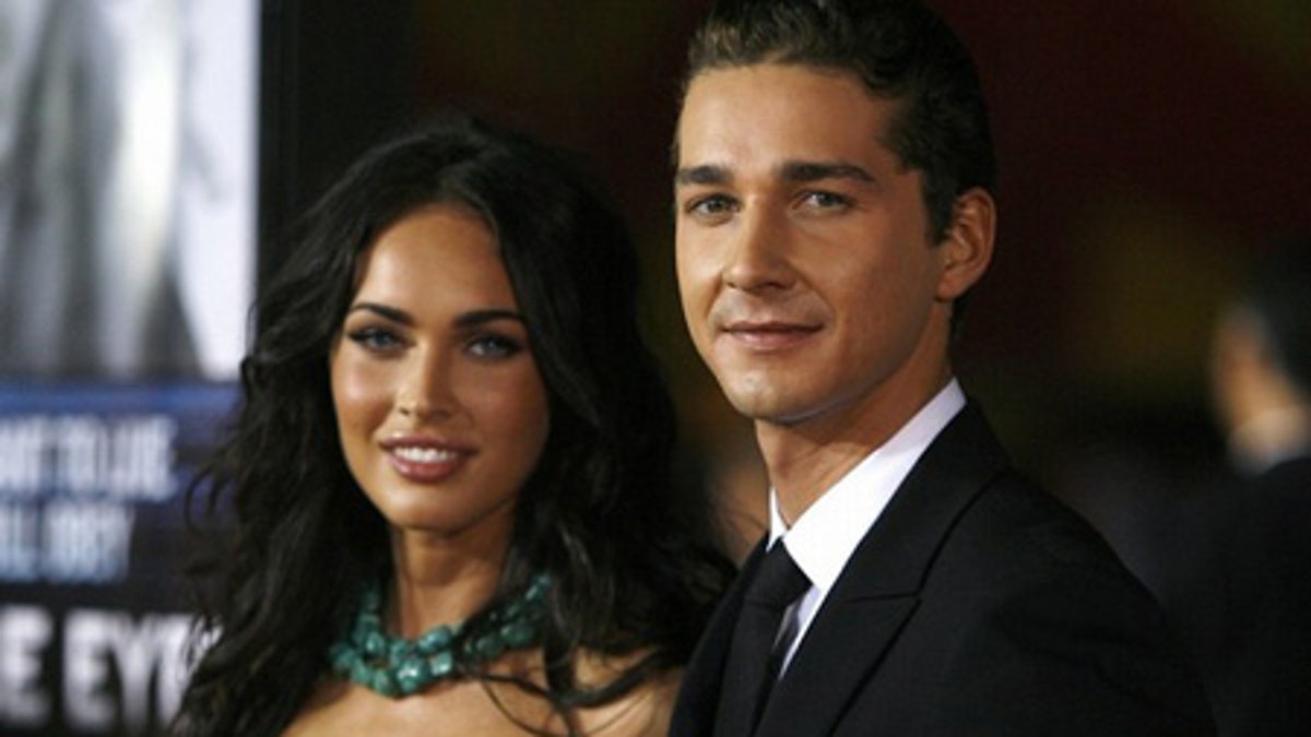 Cast member Shia LaBeouf (R) poses with actress Megan Fox at the premiere of the movie 