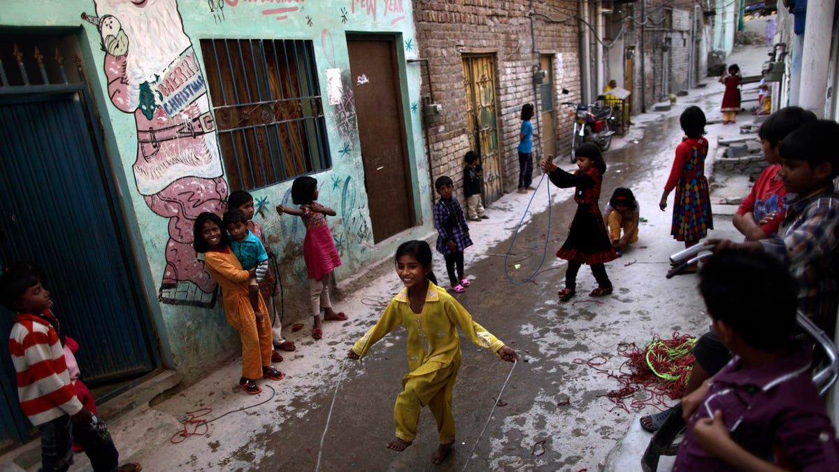 Pakistani Christian children play in an alley of a Christian neighborhood in Islamabad, Pakistan, Wednesday, April 10, 2013. Christians, Hindus, Sikhs and other religious minorities make up about 5 percent of Pakistan's 180 million residents. (AP Photo/Muhammed Muheisen)