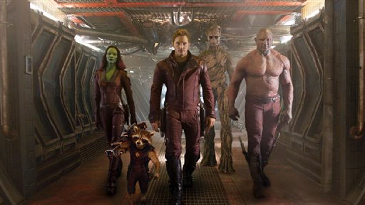 This image released by Disney - Marvel shows, from left, Zoe Saldana, the character Rocket Racoon, voiced by Bladley Cooper, Chris Pratt, the character Groot, voiced by Vin Diesel and Dave Bautista in a scene from 