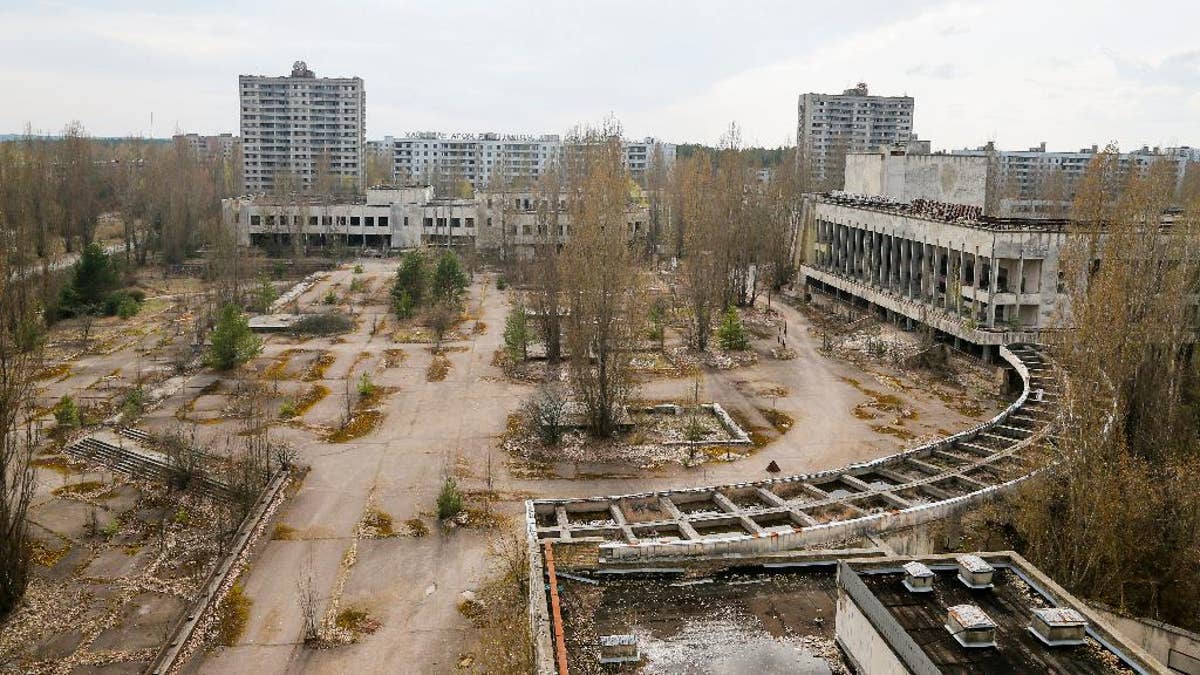 This photo taken Wednesday, April 5, 2017, shows a central square in the deserted town of Pripyat, some 3 kilometers (1.86 miles) from the Chernobyl nuclear power plant Ukraine. Once home to some 50,000 people whose lives were connected to the Chernobyl nuclear power plant, Pripyat was hastily evacuated one day after a reactor at the plant 3 kilometers (2 miles away) exploded on April 26, 1986. The explosion and the subsequent fire spewed a radioactive plume over much of northern Europe. (AP Photo/Efrem Lukatsky)