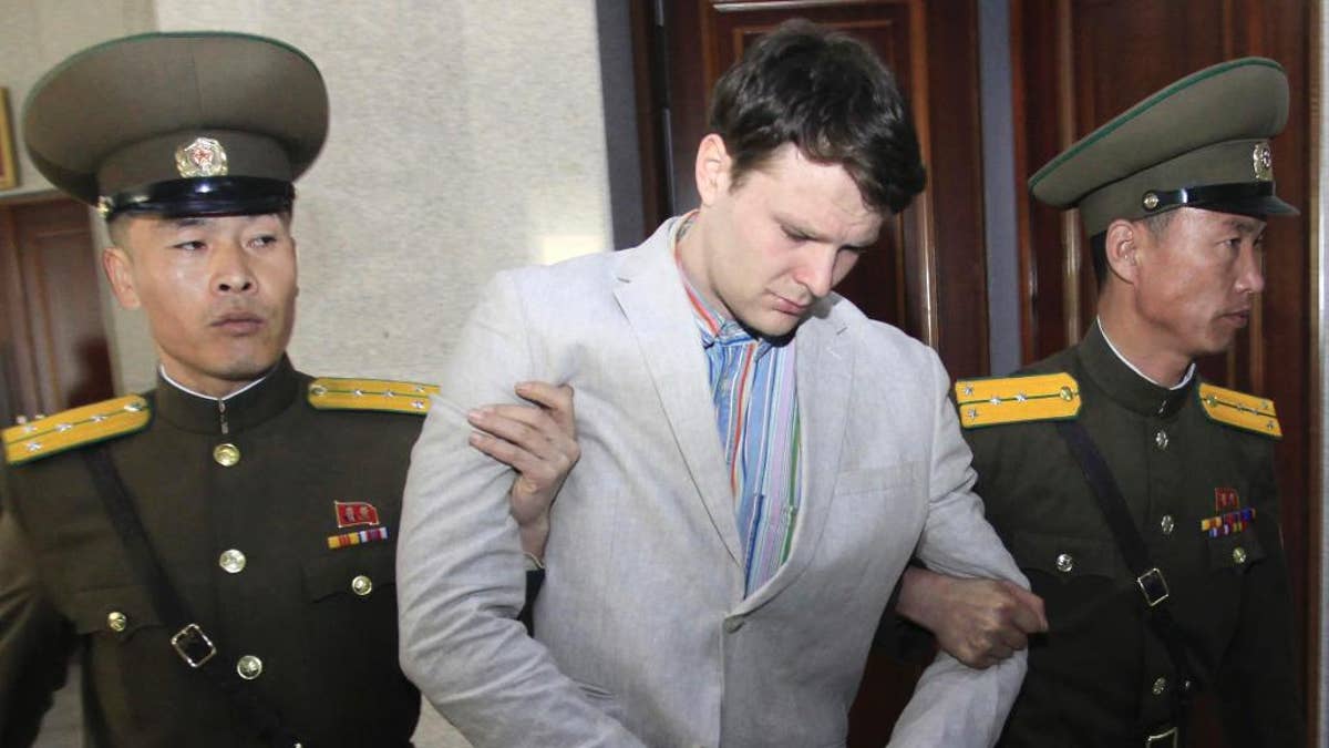 FILE - In this March 16, 2016, file photo, American student Otto Warmbier, center, is escorted at the Supreme Court in Pyongyang, North Korea. North Korea announced Warmbier's detention Jan. 22, 2016, and the University of Virginia student from suburban Cincinnati was sentenced in March 2016 to 15 years in prison at hard labor after a televised confession that he tried to steal a propaganda banner. As President Donald Trump's administration takes office one year later, there's been little public word about what has happened to Warmbier. (AP Photo/Jon Chol Jin, File)