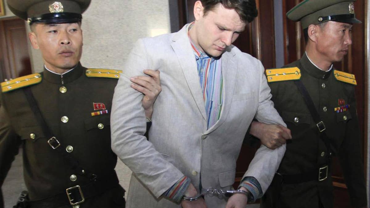 FILE - In this March 16, 2016, file photo, American student Otto Warmbier, center, is escorted at the Supreme Court in Pyongyang, North Korea. North Korea announced Warmbier's detention Jan. 22, 2016, and the University of Virginia student from suburban Cincinnati was sentenced in March 2016 to 15 years in prison at hard labor after a televised confession that he tried to steal a propaganda banner. As President Donald Trump's administration takes office one year later, there's been little public word about what has happened to Warmbier. (AP Photo/Jon Chol Jin, File)