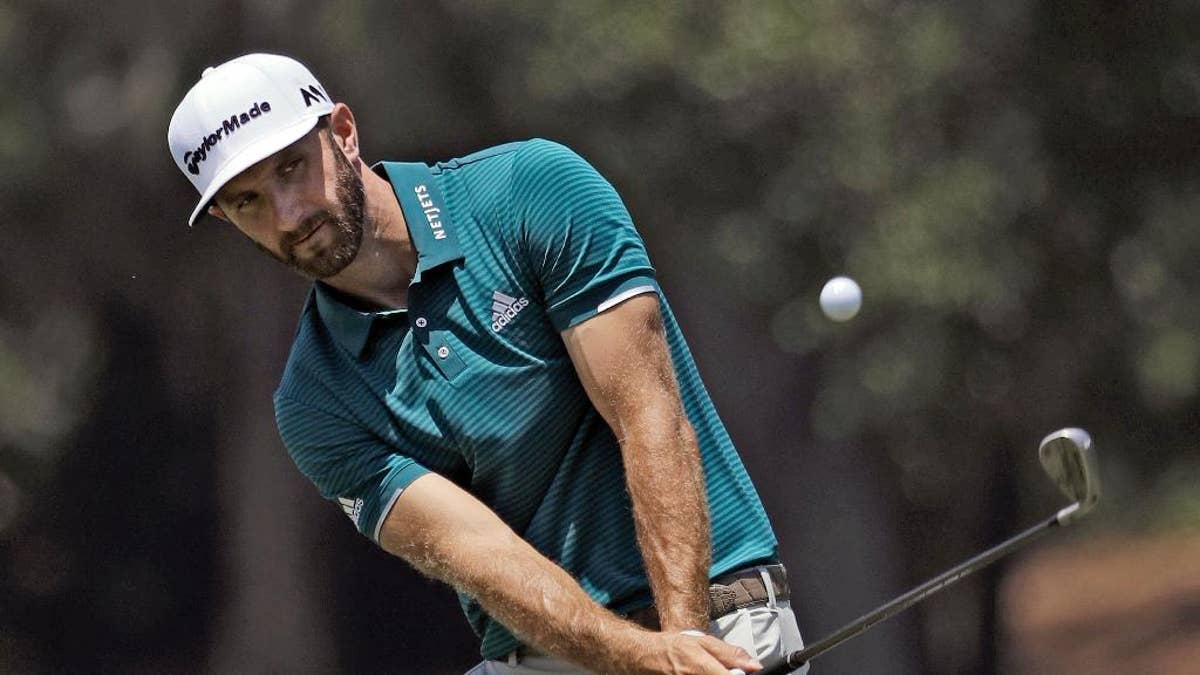 Dustin Johnson chips onto the seventh green during a practice round for The Players Championship golf tournament Wednesday, May 10, 2017, in Ponte Vedra Beach, Fla. (AP Photo/Chris O'Meara)