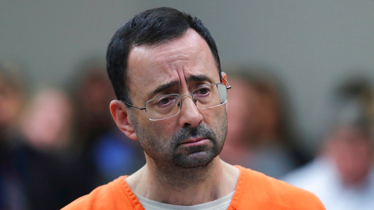 CORRECTS FROM CONVICTED TO SENTENCED - FILE - In this Nov. 22, 2017, file photo, Dr. Larry Nassar, 54, appears in court for a plea hearing in Lansing, Mich. Nassar was sentenced to decades in prison for sexually assaulting young athletes for years under the guise of medical treatment. (AP Photo/Paul Sancya, File)
