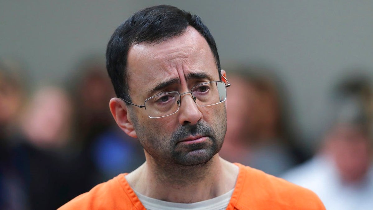 CORRECTS FROM CONVICTED TO SENTENCED - FILE - In this Nov. 22, 2017, file photo, Dr. Larry Nassar, 54, appears in court for a plea hearing in Lansing, Mich. Nassar was sentenced to decades in prison for sexually assaulting young athletes for years under the guise of medical treatment. (AP Photo/Paul Sancya, File)