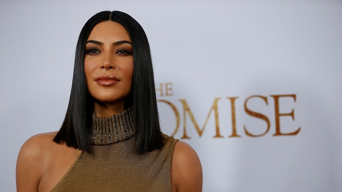 Television personality Kim Kardashian poses at the premiere of 