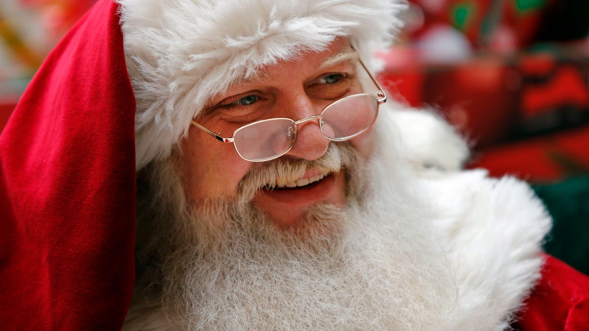 A man portraying Santa Claus sits in a mall in South Portland, Maine on Thursday, Dec. 19, 2013. Andrew Chesnut, the Bishop Walter F. Sullivan Chair in Catholic Studies at Virginia Commonwealth University, said depictions of Santa Claus as a white man came about mainly because he was a European import, a blend of the Dutch Sinterklaas and British folklore character Father Christmas, with elements of Saint Nicholas, a 4th-century Greek bishop in modern-day Turkey. (AP Photo/Robert F. Bukaty)