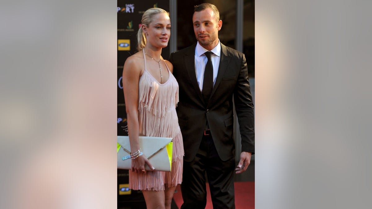 FILE - This Nov. 4, 2012 file photo shows Oscar Pistorius and Reeva Steenkamp at an awards ceremony in Johannesburg, South Africa. Far from the courtroom drama that has gripped South Africa, the family of Pistorius' slain girlfriend, Steenkamp, has struggled with its own private deluge of grief, frustration and bewilderment. The victim's relatives also harbor misgivings about efforts by the Olympian's family to reach out to them with condolences. Pistorius, meanwhile, spent Saturday, Feb. 23, 2013 at his uncle's home in an affluent suburb of Pretoria, the South African capital, after a judge released him on bail. (AP Photo/City Press, Lucky Nxumalo) SOUTH AFRICA OUT