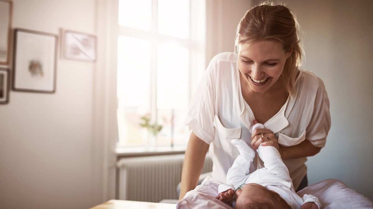 Shot of a young woman bonding with her baby girl at home