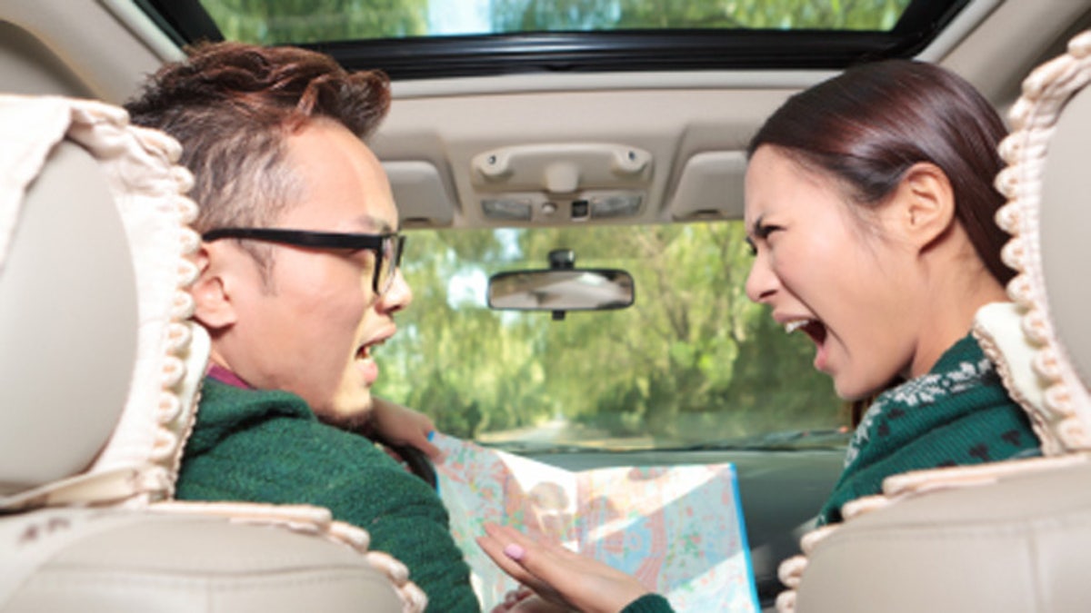 af8369c4-Young couple in car with map