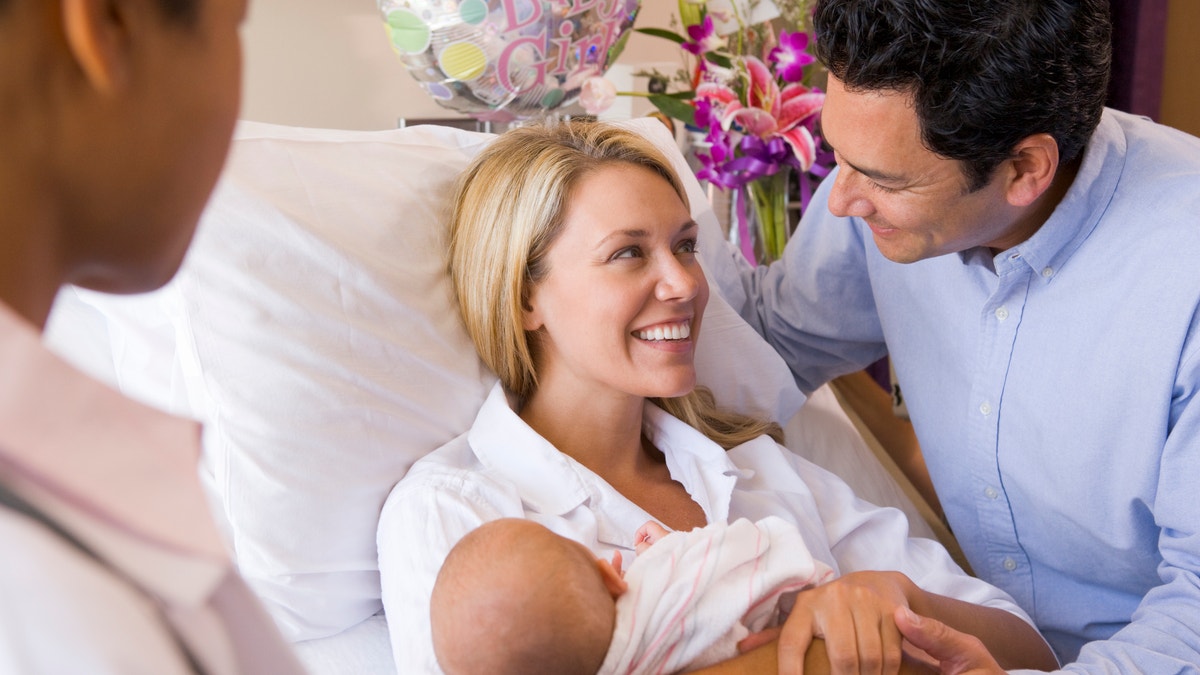 balloons and flowers in hospital room newborn baby parents istock