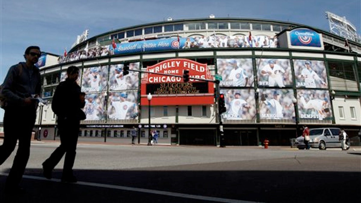 April 4, 2012: People walk by the Marquee at Wrigley Field, one day before the Chicago Cubs' home opener against the Washington Nationals in Chicago. 