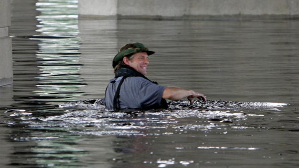person swimming in katrina flooding