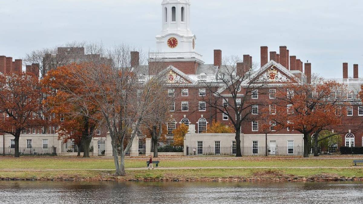 FILE - This Nov. 13, 2008 file photo shows the campus of Harvard University in Cambridge, Mass. Harvard University is taking new steps to confront its past ties to slavery. The Ivy League school is hosting a conference Friday, March 3, 2017, exploring the historical ties between slavery and early universities, including Harvard. (AP Photo/Lisa Poole, File)