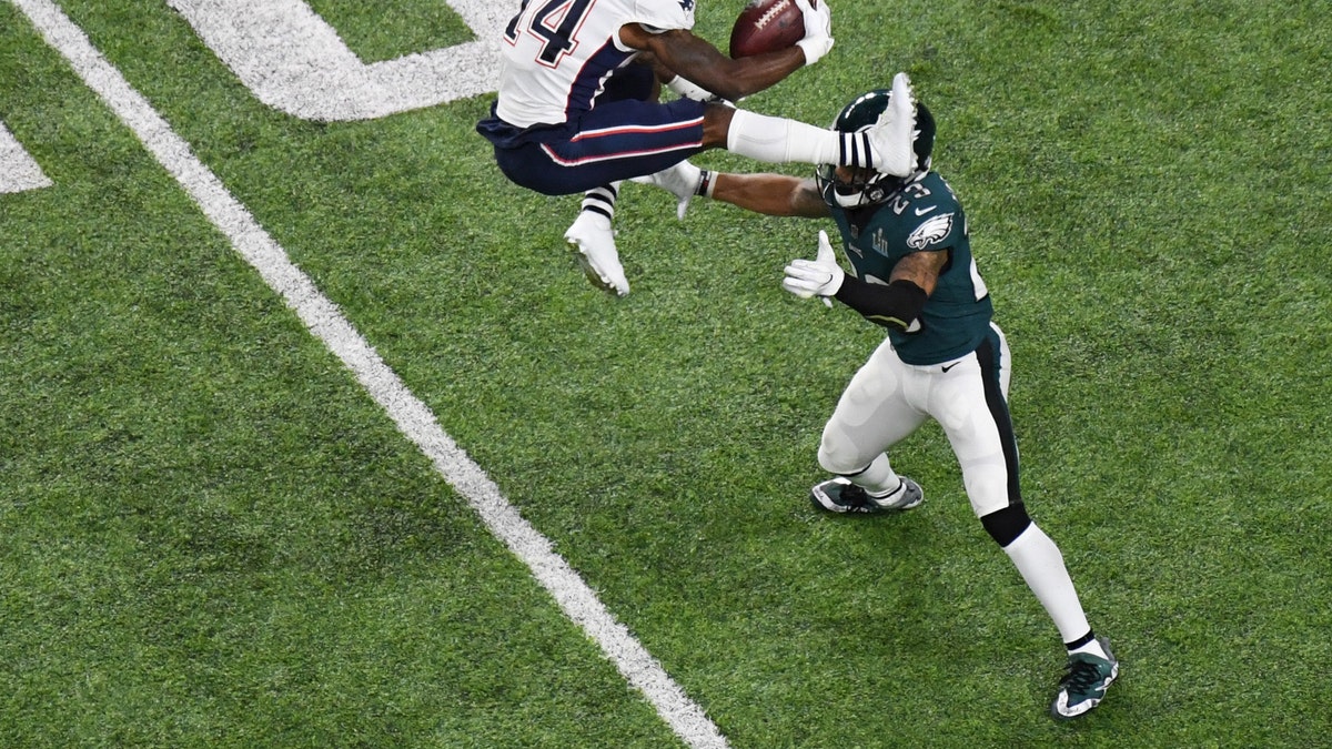 Feb 4, 2018; Minneapolis, MN, USA; New England Patriots wide receiver Brandin Cooks (14) attempts to hurdle Philadelphia Eagles free safety Rodney McLeod (23) in the first half in Super Bowl LII at U.S. Bank Stadium. Mandatory Credit: Kirby Lee-USA TODAY Sports - 10588046