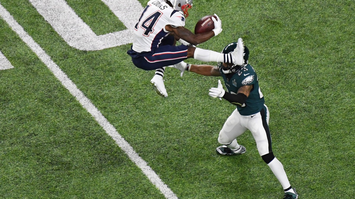 Feb 4, 2018; Minneapolis, MN, USA; New England Patriots wide receiver Brandin Cooks (14) attempts to hurdle Philadelphia Eagles free safety Rodney McLeod (23) in the first half in Super Bowl LII at U.S. Bank Stadium. Mandatory Credit: Kirby Lee-USA TODAY Sports - 10588046