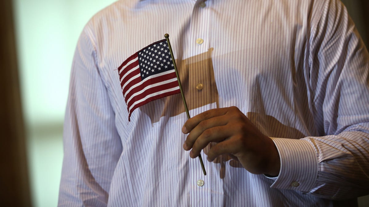 New citizen holding a U.S. flag