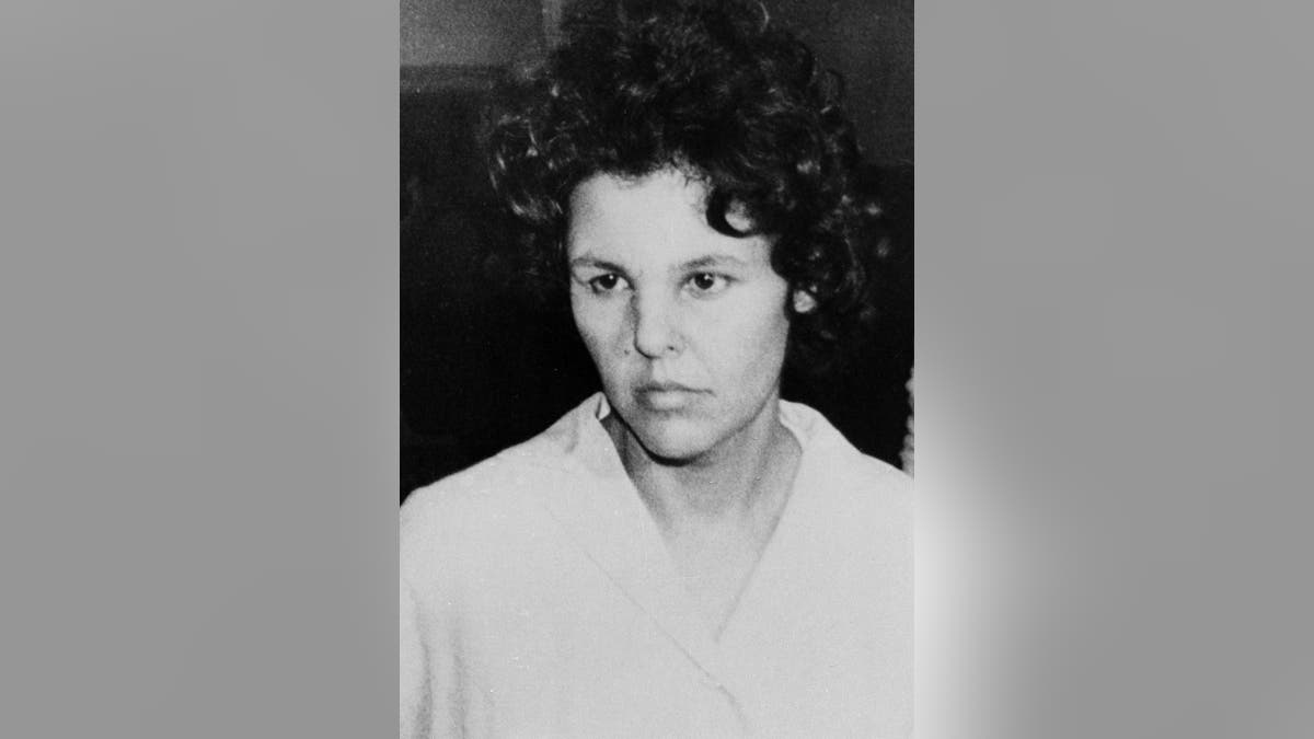 FILE - In this Oct. 21, 1981 file photo, Judith Clark is taken into police custody in Nanuet, N.Y. On Friday, April 21, 2017, New York's Parole Board has denied Clark parole. The former Weather Underground radical drove a getaway car in the1981 Brinks armored car robbery that left three people dead. She has served 35 years of a 75-years-to-life sentence. (AP Photo/David Handschuh, File)