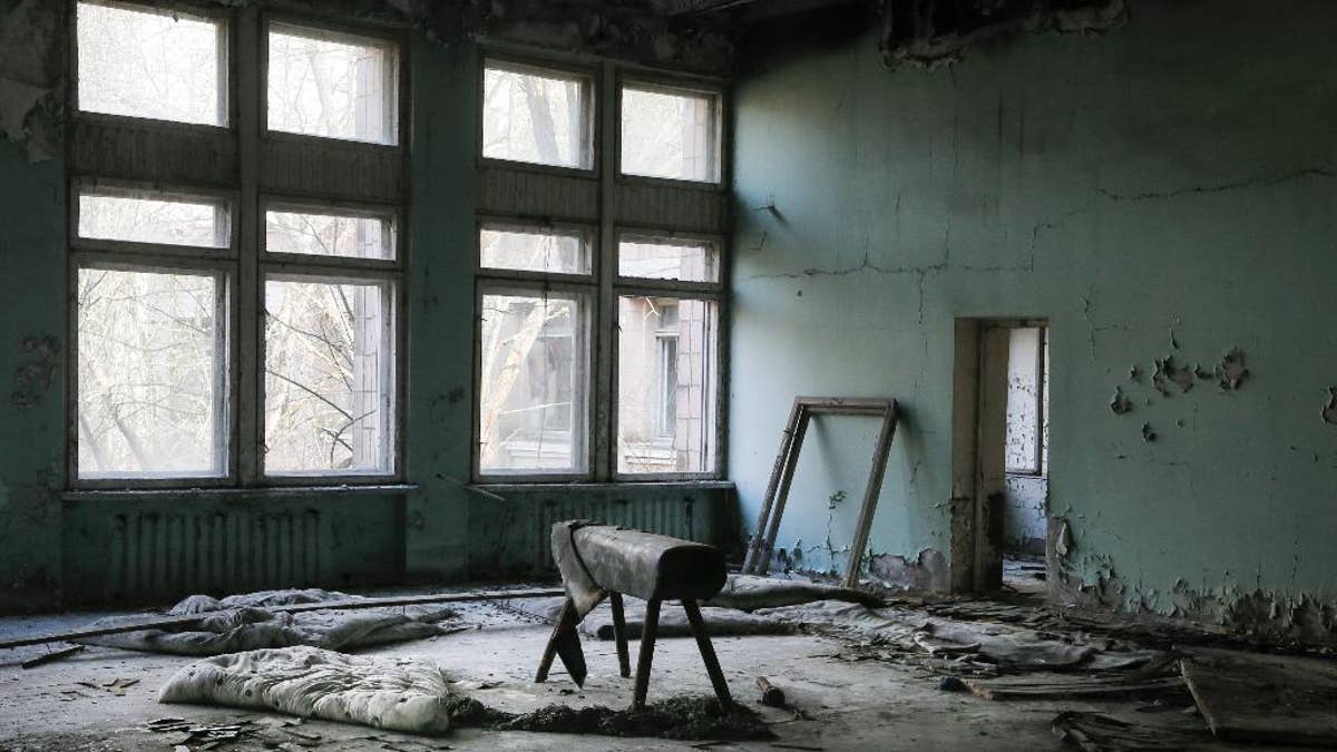 This photo taken Wednesday, April 5, 2017, shows a gymnasium in a school in the deserted town of Pripyat, some 3 kilometers (1.86 miles) from the Chernobyl nuclear power plant Ukraine. Once home to some 50,000 people whose lives were connected to the Chernobyl nuclear power plant, Pripyat was hastily evacuated one day after a reactor at the plant 3 kilometers (2 miles away) exploded on April 26, 1986. The explosion and the subsequent fire spewed a radioactive plume over much of northern Europe. (AP Photo/Efrem Lukatsky)