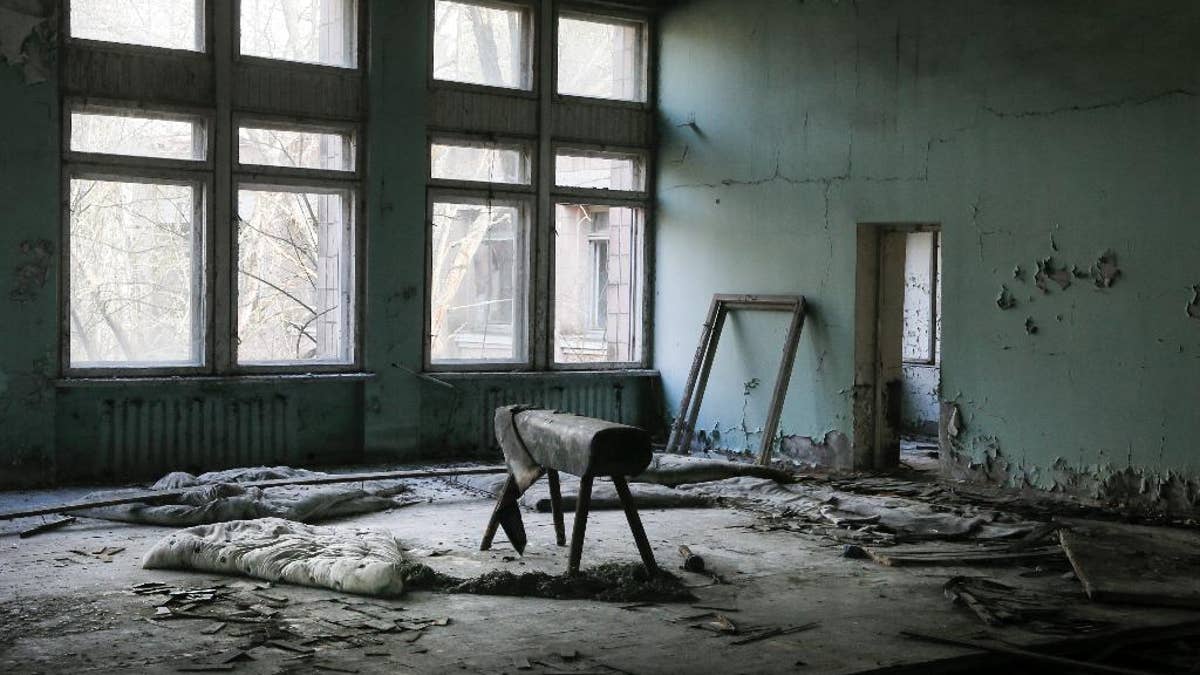 This photo taken Wednesday, April 5, 2017, shows a gymnasium in a school in the deserted town of Pripyat, some 3 kilometers (1.86 miles) from the Chernobyl nuclear power plant Ukraine. Once home to some 50,000 people whose lives were connected to the Chernobyl nuclear power plant, Pripyat was hastily evacuated one day after a reactor at the plant 3 kilometers (2 miles away) exploded on April 26, 1986. The explosion and the subsequent fire spewed a radioactive plume over much of northern Europe. (AP Photo/Efrem Lukatsky)