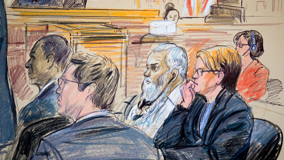 This courtroom sketch shows Ahmed Abu Khattala, third from right, listening to an interpreter through earphones during the opening statement by his defense attorney Jeffery Robinson in federal court in Washington Monday, Oct. 2, 2017. Khattala, the suspected mastermind of the 2012 attacks on a diplomatic compound in Benghazi, Libya, that killed four Americans, is on trial. Also depicted are members of the defense team Cole Lutermilch, left, and Michelle Peterson, second from right. (Dana Verkouteren via AP)