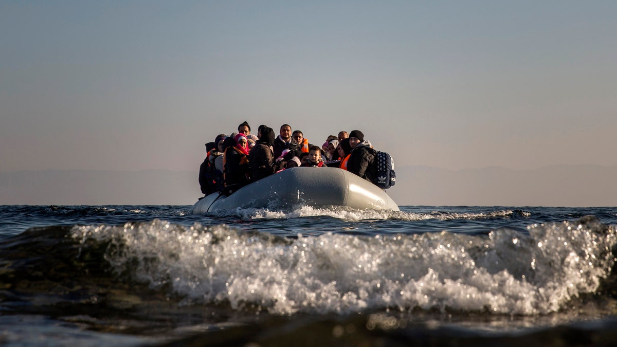 Refugees approach the Greek island of Lesbos on a dinghy