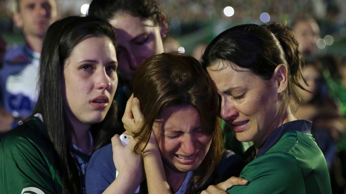 Relatives of Chapecoense soccer players, who died in a plane crash in Colombia, cry during a memorial inside Arena Condado stadium in Chapeco, Brazil, Wednesday, Nov. 30, 2016. Authorities were working to finish identifying the bodies before repatriating them to Brazil. (AP Photo/Andre Penner)