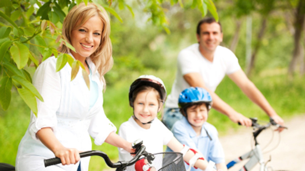 Cheerful family riding bicycles.
